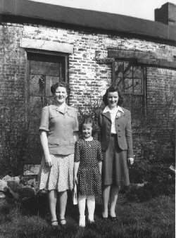 Photo, circa 1940, of three Jergens sisters in front of the old brick house that stood on Phillip Jergens, Sr.'s land.